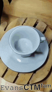 a cup and saucer on a wooden tray with the name evansctmfam