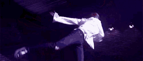 a person is standing on a purple surface with their legs crossed .