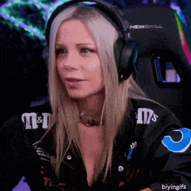 a woman wearing headphones and a jacket with m & m 's on it