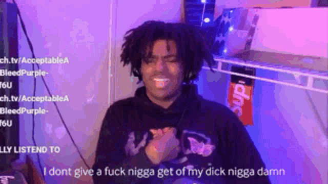a man with dreadlocks is wearing headphones and a hoodie that says mad on it .
