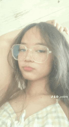 a girl wearing glasses and a plaid shirt is taking a selfie with the hashtag @_cool_