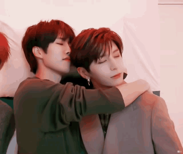 two young men are hugging each other with the letters nc on the bottom