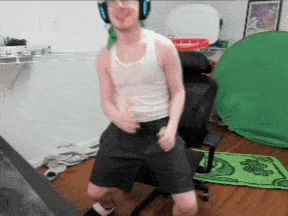 a man wearing headphones and a white tank top is dancing