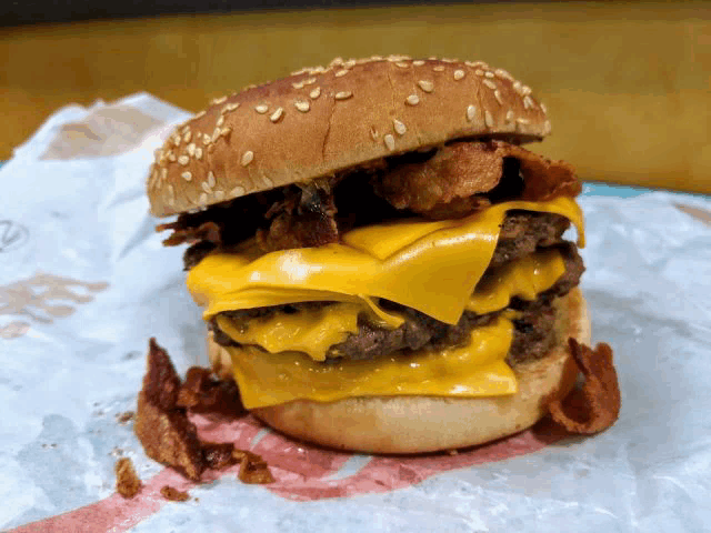 a burger with cheese and bacon on a bun