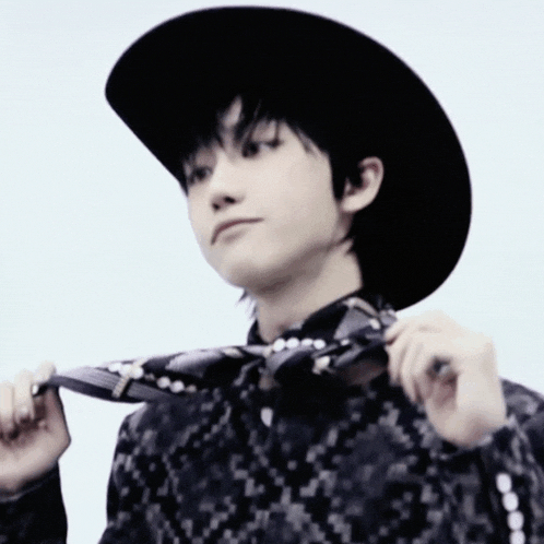 a man wearing a cowboy hat and a tie