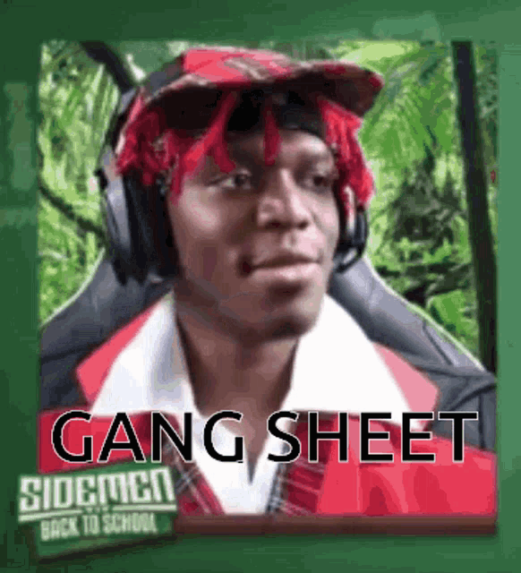 a man wearing headphones and a red bandana is sitting in front of a green chalkboard .