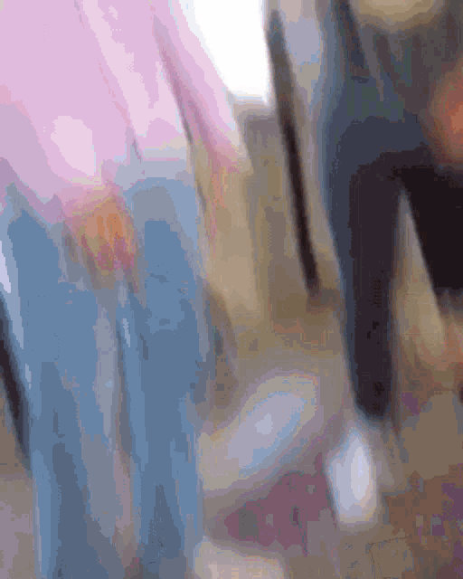 a blurry picture of a person standing next to each other .
