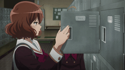a girl is looking into a locker that says ' tdd ' on it