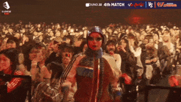 a crowd of people watching a match with the number 17 on the screen