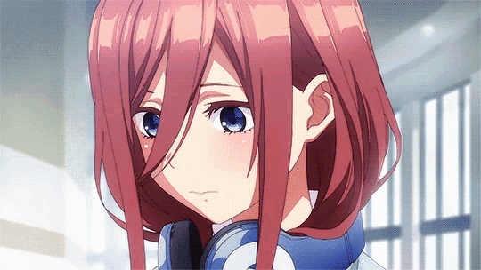 a girl with red hair and blue eyes is wearing headphones .
