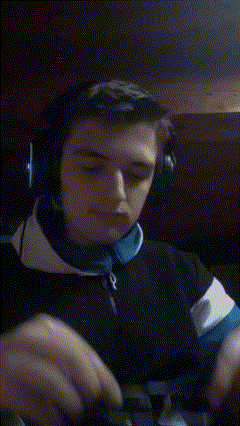 a man wearing headphones and sunglasses is covering his mouth