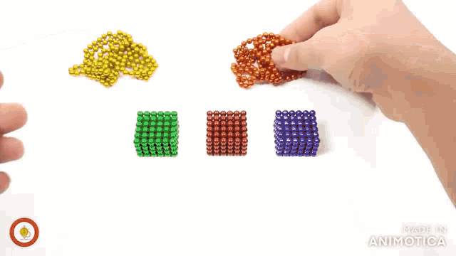 a person is holding a bunch of beads in their hand