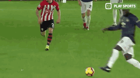 a group of soccer players are playing a game of soccer on a soccer field .
