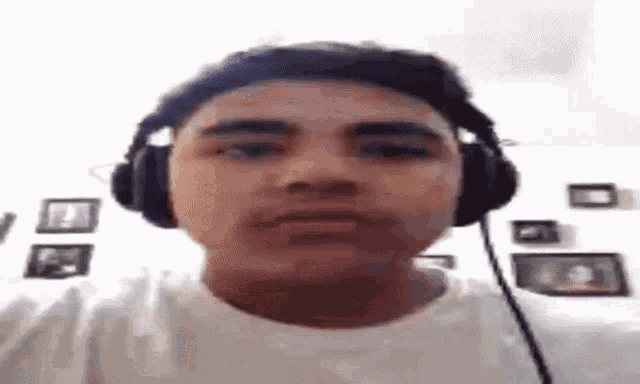 a man wearing headphones is making a funny face .