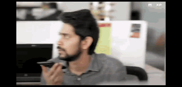 a blurry picture of a man talking on a phone
