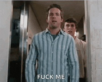 a man in a blue and white striped shirt is standing in a hallway and says `` fuck me '' .
