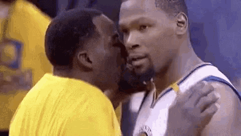 two basketball players are kissing each other on the cheeks .