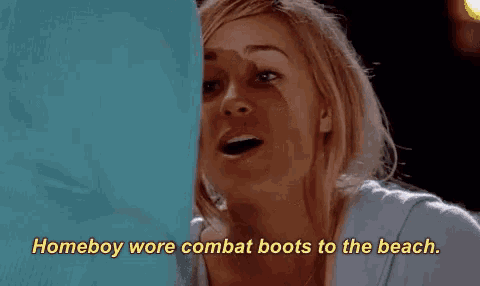 a woman in a blue shirt is saying homeboy wore combat boots to the beach