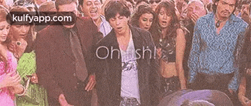 a man is dancing in a crowd of people .