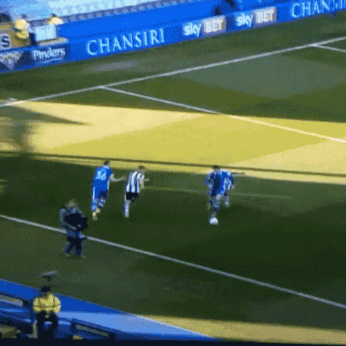 a soccer game is being played in a stadium with a banner for chansiri