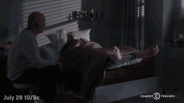 an advertisement for comedy central shows a man sitting next to an elderly woman laying in a hospital bed