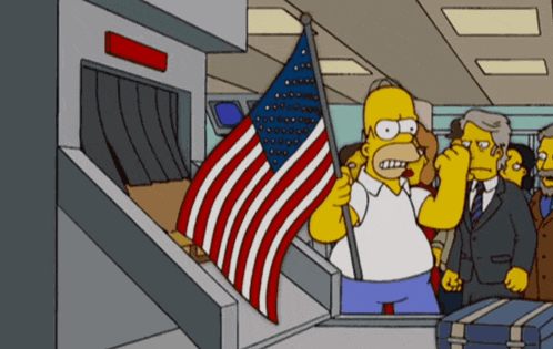 a cartoon of homer simpson holding an american flag in an airport