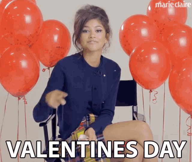a woman is sitting in a chair with red balloons and the words valentine 's day written below her
