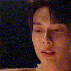 a close up of a young man 's face with a blurred background .
