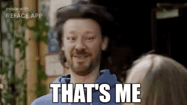 a man with a beard is smiling and saying `` that 's me '' while looking at a woman .