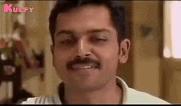a man with a mustache is making a funny face .