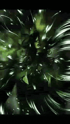 a man with glasses is standing in a dark room surrounded by a green background .