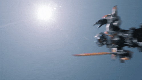 a robot is flying in the sky with the sun shining behind it