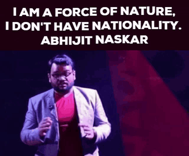 a man in a suit and red shirt is standing in front of a sign that says `` i am a force of nature '' .