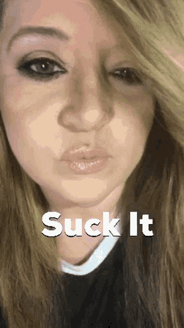 a close up of a woman 's face with the words " suck it " below her