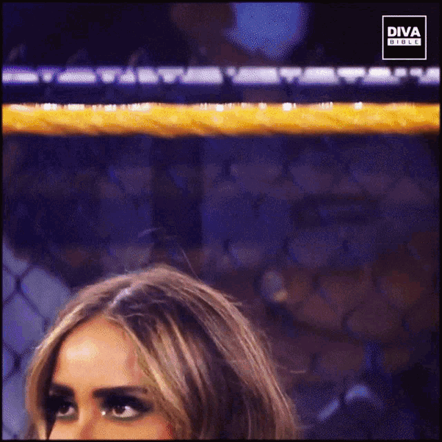 a woman in a boxing ring with diva girls on the bottom