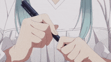 a girl is writing in a notebook with a pen