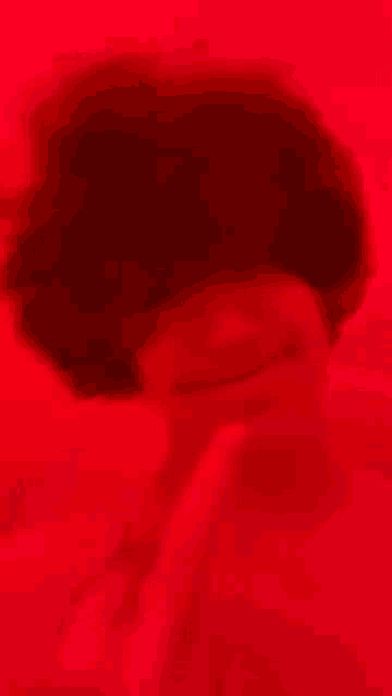 a close up of a red background with smoke coming out of it
