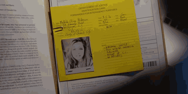 a department of justice identification card with a photo of a woman on it