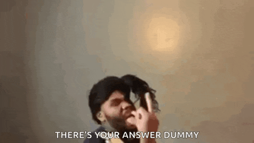 a man with a beard is holding a wig in his hand and making a funny face .