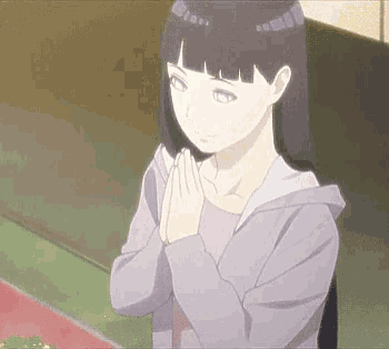 a girl in a purple hoodie is praying with her hands folded