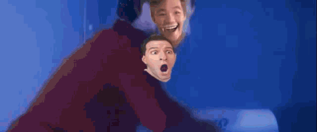 three men are standing in front of a blue background with their faces behind them