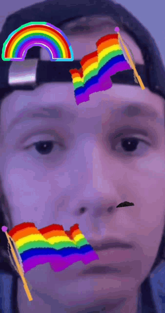 a man wearing a hat with a rainbow and a rainbow flag on his face
