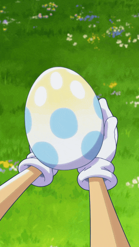 a person is holding a blue and white egg in their hands