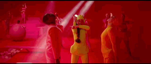 a group of people are standing in a room with red walls