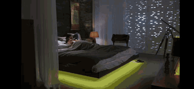 a person laying on a bed in a room with a telescope
