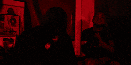 a man is taking a picture of himself with a green light behind him