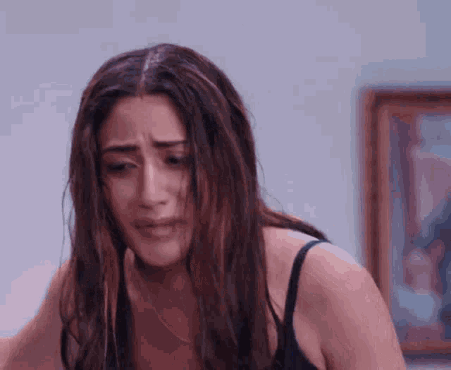 a woman in a black bra is making a funny face .