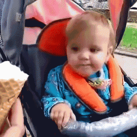 a baby is sitting in a stroller with an ice cream cone behind him