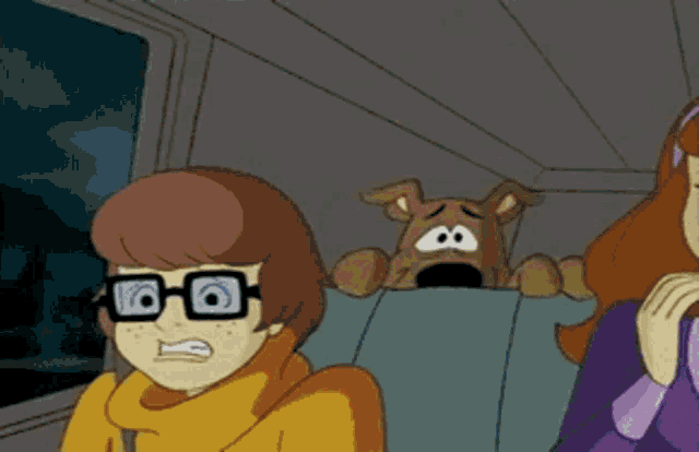 scooby doo and his friends are sitting in the back seat of a car