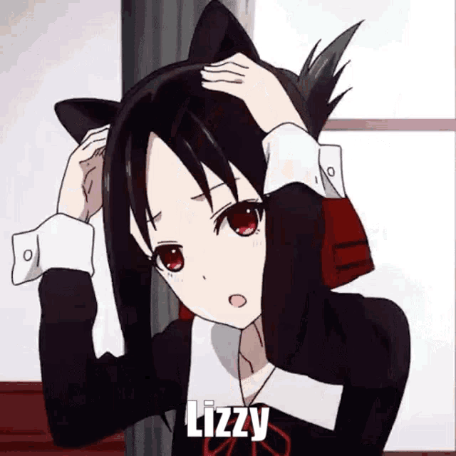 a girl with cat ears on her head is holding her hair in her hands .